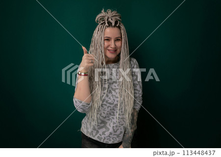 Woman With Long Blonde Dreadlocks Giving a Thumbs Up 113448437