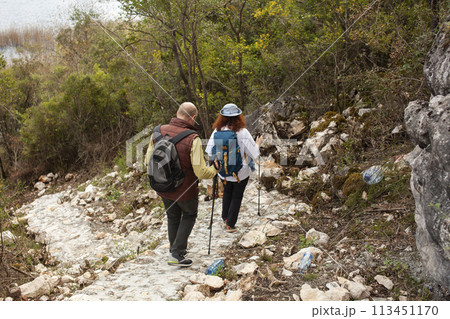 senior couple hiking outdoor, man and woman norwegian walking with sticks landscape senior couple hiking outdoor, man and woman norwegian walking with sticks landscape 113451170