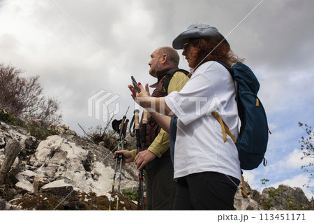 senior couple hiking outdoor, man and woman norwegian walking with sticks landscape senior couple hiking outdoor, man and woman norwegian walking with sticks landscape 113451171
