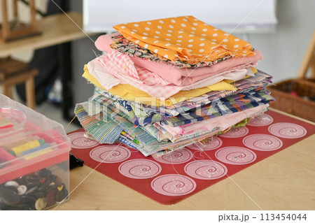 Colorful Cotton Fabric Scraps Pile for Creative Design Projects on White Background 113454044