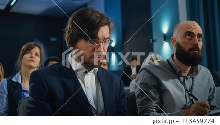 Diverse media workers raise hands during press campaign in the conference room 113459774