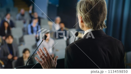 Back view of politician or activist pronouncing speech during press campaign 113459850