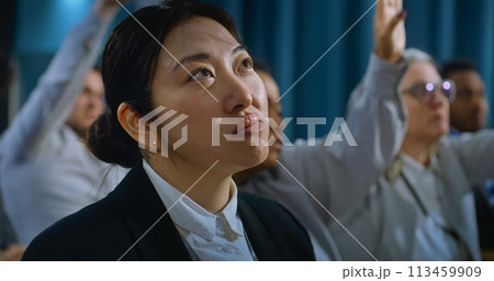 Portrait of Asian female journalist raising hand to ask question Portrait of Asian female journalist raising hand to ask question 113459909