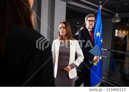 Female EU politician poses for the cameras and greets journalists 113460117
