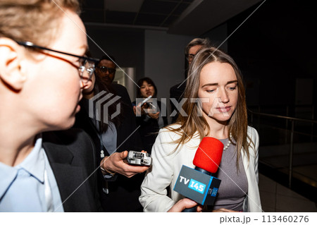 Female US politician surrounded by crowd of journalists Female US politician surrounded by crowd of journalists 113460276