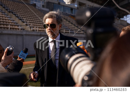 Interview of football team director at press conference for TV 113460283