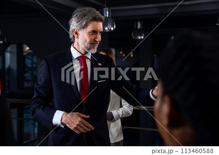 President of the USA waves his hand and poses for media cameras President of the USA waves his hand and poses for media cameras 113460588