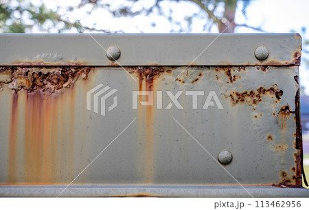 Rusted and peeling paint on an electrical transformer exposed to the elements. Rusted and peeling paint on an electrical transformer exposed to the elements. 113462956