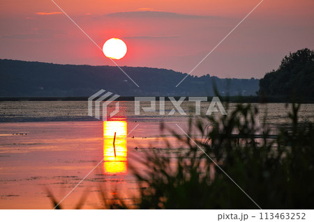 Amazing sunset over calm lake. 113463252