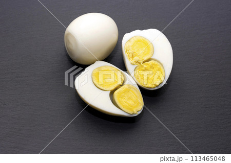 egg with two yolks on a black background.	 113465048