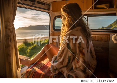 A woman in the camper van enjoying the view out the window on a bright morning A woman in the camper van enjoying the view out the window on a bright morning 113465482