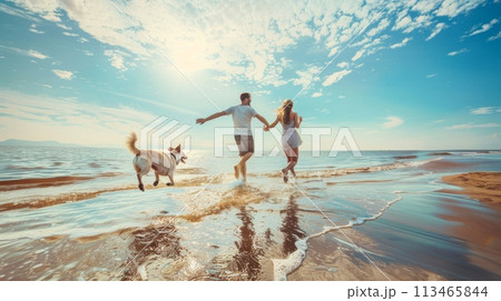 Man and Woman Running on Beach With Dog 113465844