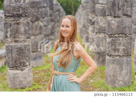 Beautiful tourist woman observing the old pyramid and temple of the castle of the Mayan architecture known as Chichen Itza these are the ruins of this ancient pre-columbian civilization and part of 113466113