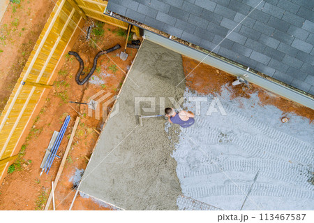 In preparation for driveway of new house wet cement has been poured 113467587