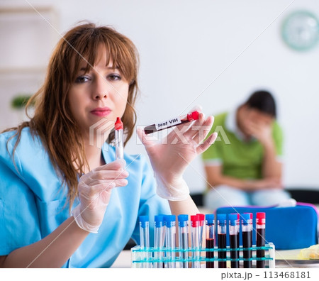 Young lab assistant testing blood samples in hospital 113468181