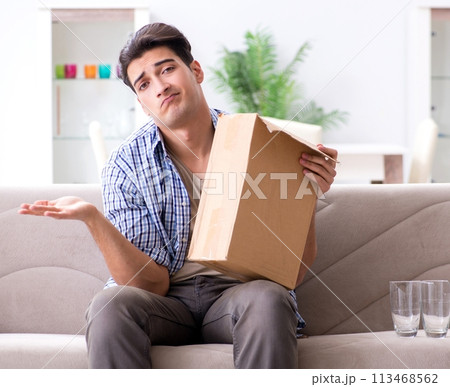 Man receiving wrong parcel with glasses 113468562