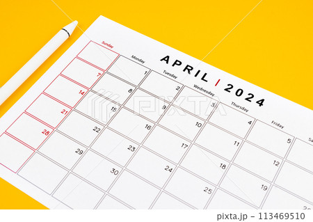 April 2024 desk calendar and pen on yellow color background. April 2024 desk calendar and pen on yellow color background. 113469510