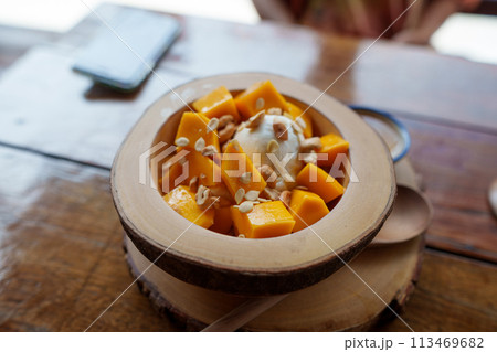 Mango yogurt on the table in a dessert shop 113469682