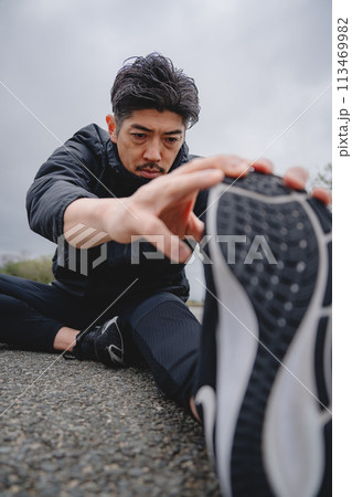 屋外で柔軟体操をする男性 113469982
