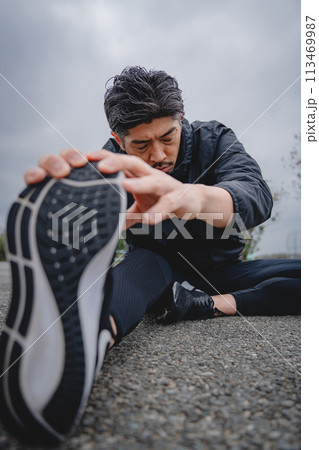 屋外で柔軟体操をする男性 113469987