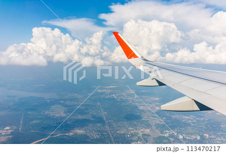 View from the airplane window during taking off on a clear summer morning 113470217