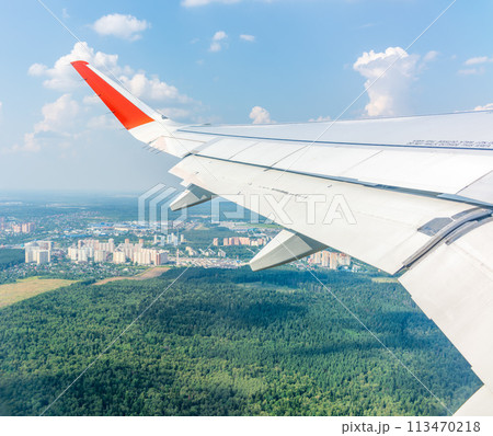 View from the airplane window during taking off on a clear summer morning View from the airplane window during taking off on a clear summer morning 113470218