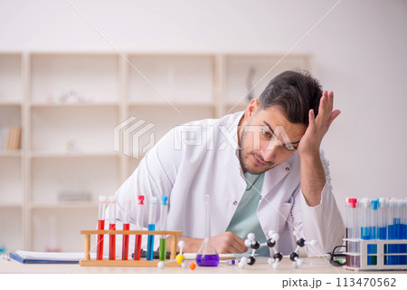 Young male chemist sitting at the lab Young male chemist sitting at the lab 113470562