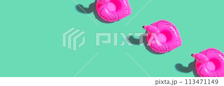 Summer concept with pink flamingo floats Summer concept with pink flamingo floats 113471149