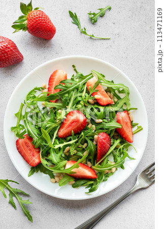 Fresh Strawberry Arugula Salad With Pine Nuts Served on a Bright Day 113471169