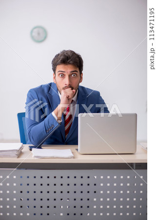 Young male employee working in the office Young male employee working in the office 113471195