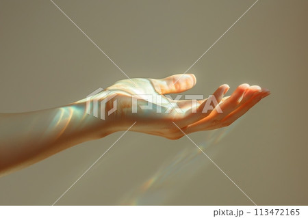 A hand is shown with a light shining on it 113472165