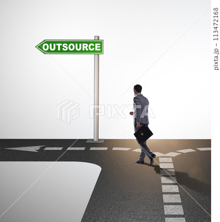 Businessman at crossroads deciding between outsourcing and inhou 113472168