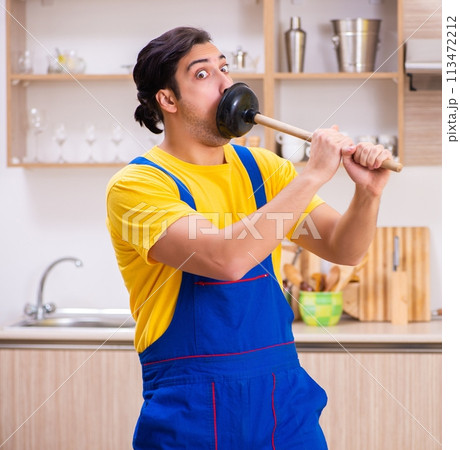 Young male contractor repairing tap at home Young male contractor repairing tap at home 113472212
