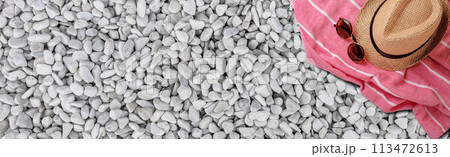 Summer Straw Hat, Towel and Sunglasses on White Pebbles Stone Background. File with Clipping Path. 113472613