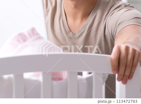 Young dad student preparing for exams and looking after baby Young dad student preparing for exams and looking after baby 113472783