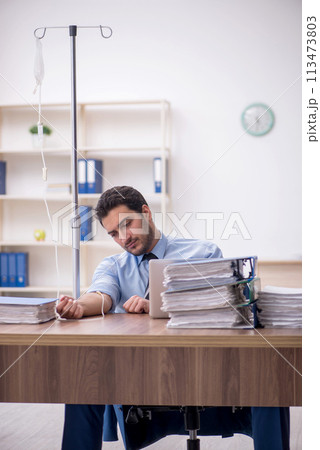 Young male employee suffering at workplace 113473803