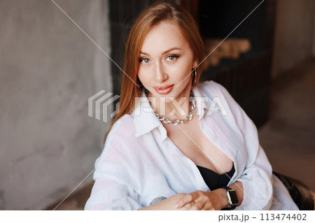 Portrait of sexy redhead young woman in white shirt. Portrait of sexy redhead young woman in white shirt. 113474402