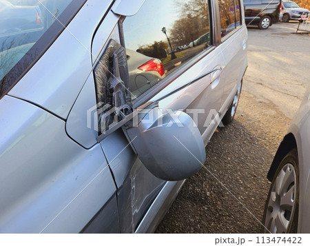Broken side mirror of the car. An accident on the road. Broken side mirror of the car. An accident on the road. 113474422