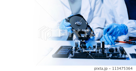 Technician repairing inside of hard disk drive by screwdriver. the concept of data, hardware, technician and technology. computer hardware, upgrade . Technician repairing inside of hard disk drive by screwdriver. the concept of data, hardware, technician and technology. computer hardware, upgrade . 113475364