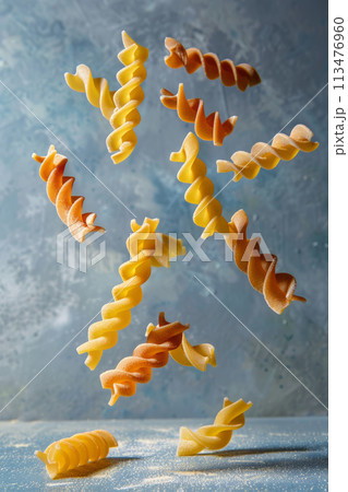 Several pieces of colorful fusilli floating in the air. Generative AI 113476960