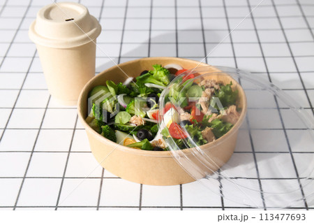 Tuna salad in a cardboard plate on a light table. Tuna salad in a cardboard plate on a light table. 113477693