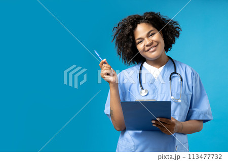 A young African American woman in a doctor's uniform 113477732