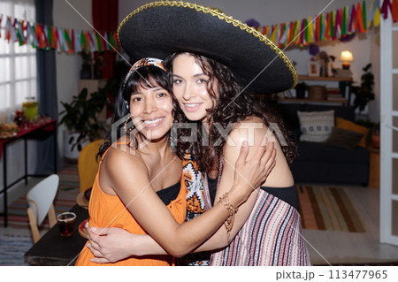 Two happy girl enjoying home party Two happy girl enjoying home party 113477965