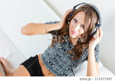 woman in big headphones listening music mp3 relaxing 113477997