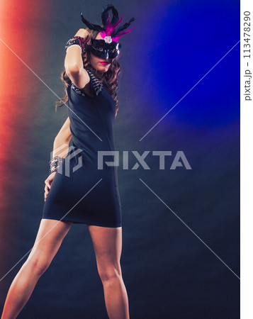 Woman with carnival venetian mask on dark Woman with carnival venetian mask on dark 113478290