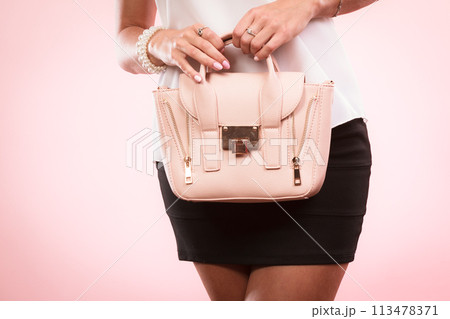 Fashionable girl holding bag handbag. Fashionable girl holding bag handbag. 113478371