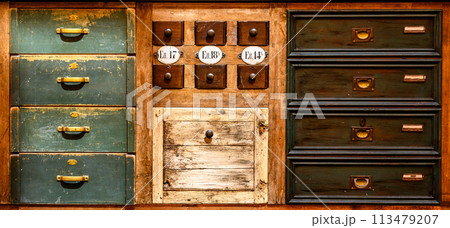 Front of vintage drawers, different in size, shape, color and design 113479207