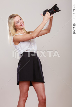 Beautiful woman with camera. 113479305