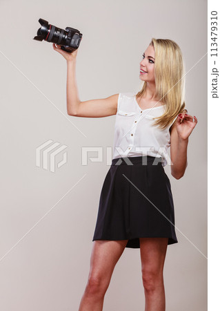 Beautiful woman with camera. Beautiful woman with camera. 113479310