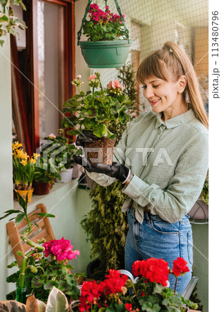 Gardener Woman Taking Care of Plants and Flowers Gardener Woman Taking Care of Plants and Flowers 113480796
